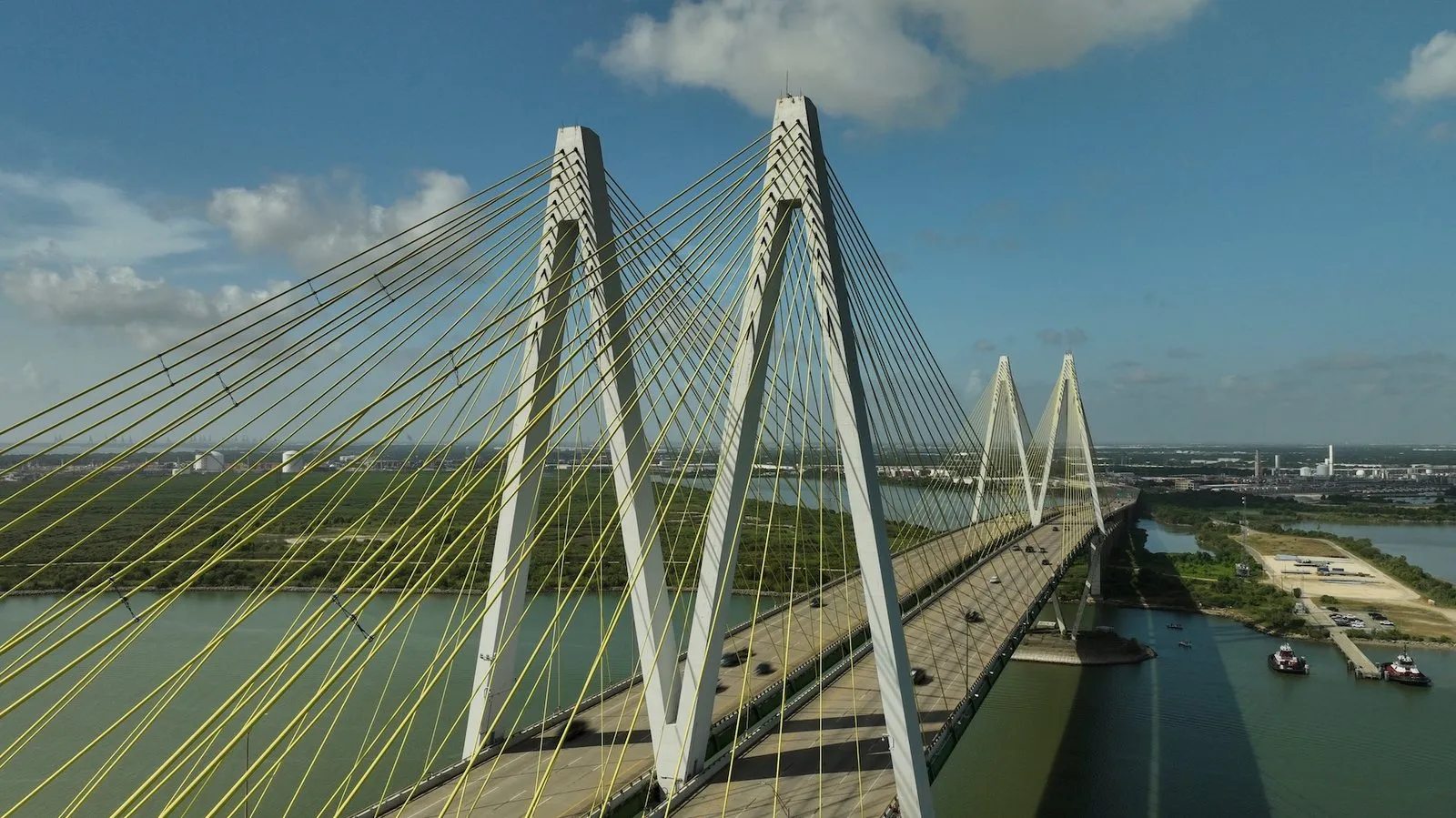 Fred Hartman Bridge over the Houston Ship Channel at Baytown, Texas, with tugboats below