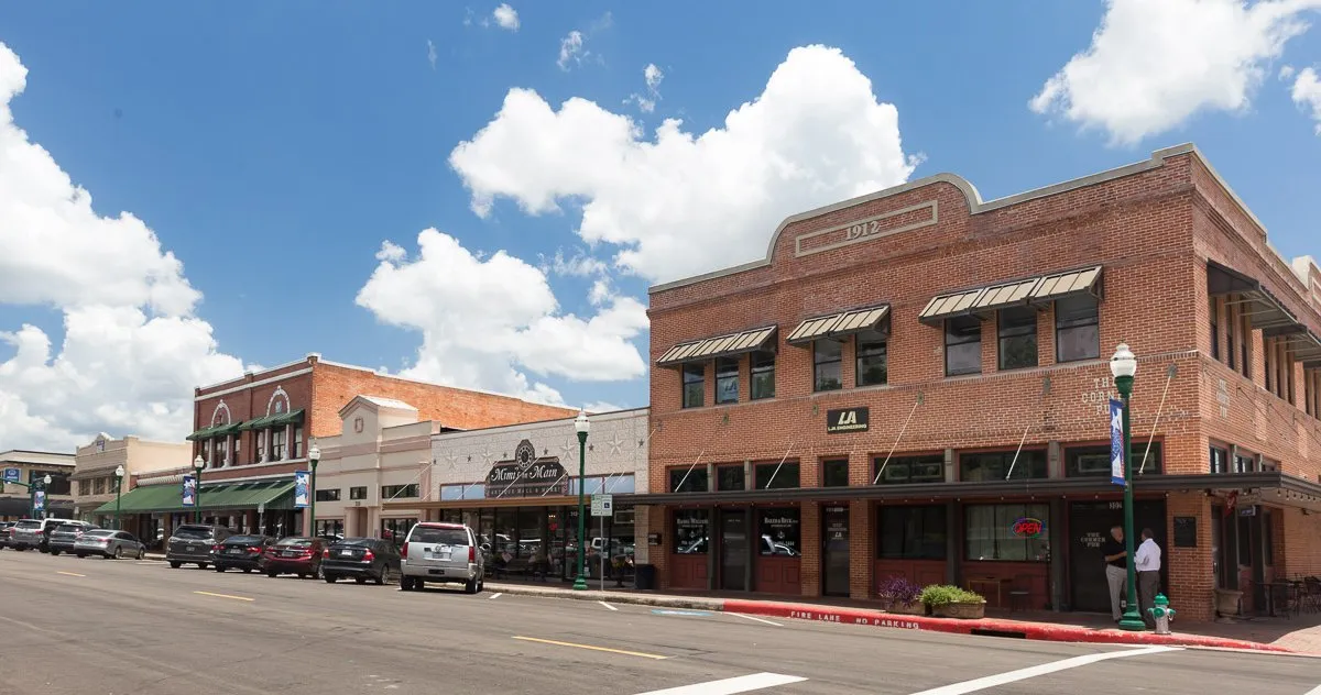 Downtown Conroe, Texas: brick storefronts along the street, one dated 1912