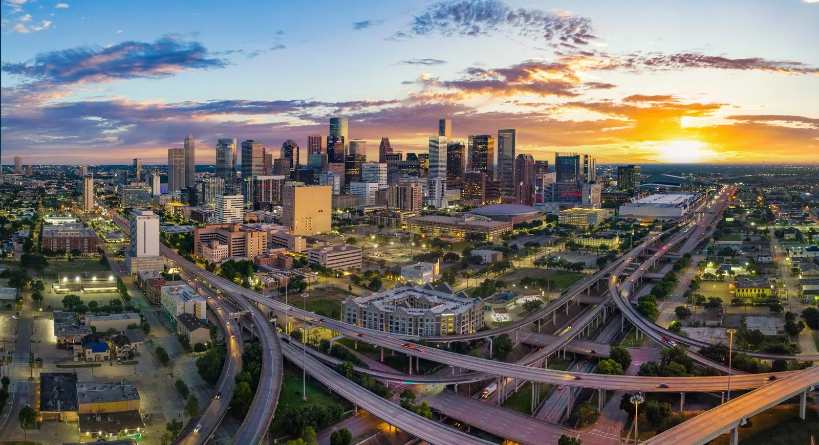 Aerial view of the downtown Houston, Texas skyline and freeway interchange at sunset