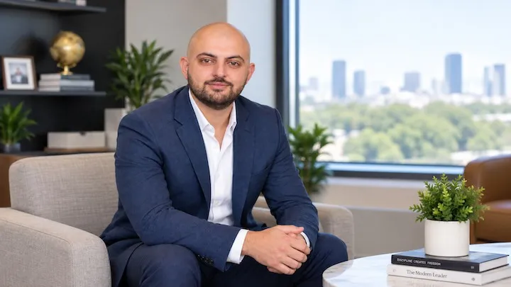 Luka Cenaj, Agency Principal of Aulona Insurance Group, seated in a navy suit