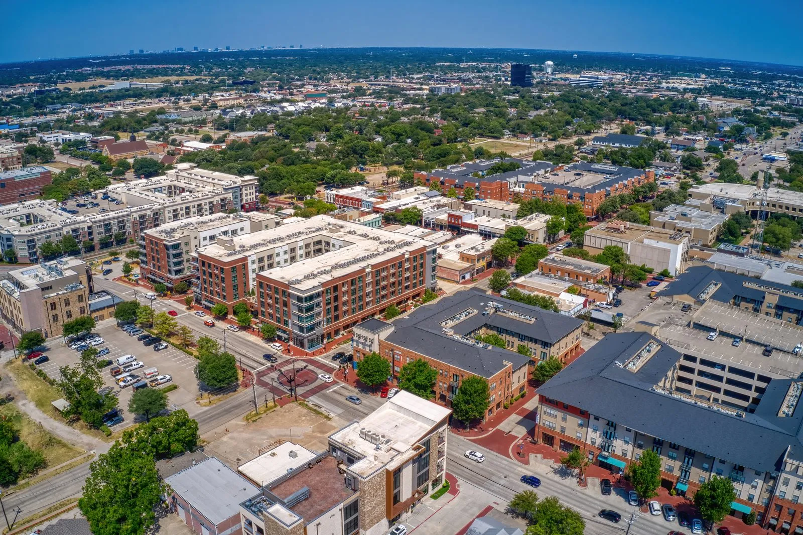 Aerial view of downtown Plano, Texas, with brick mid-rise apartments and shops