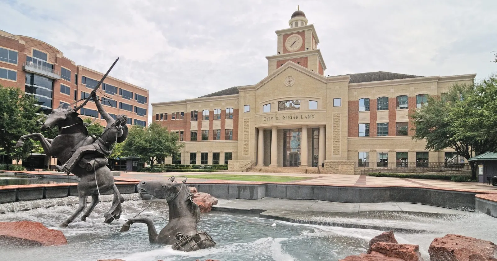 Sugar Land City Hall in Sugar Land, Texas, with the fountain and horse-and-rider sculpture in Town Square